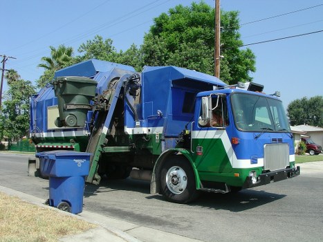 Company staff handling a skip hire complaint at a desk